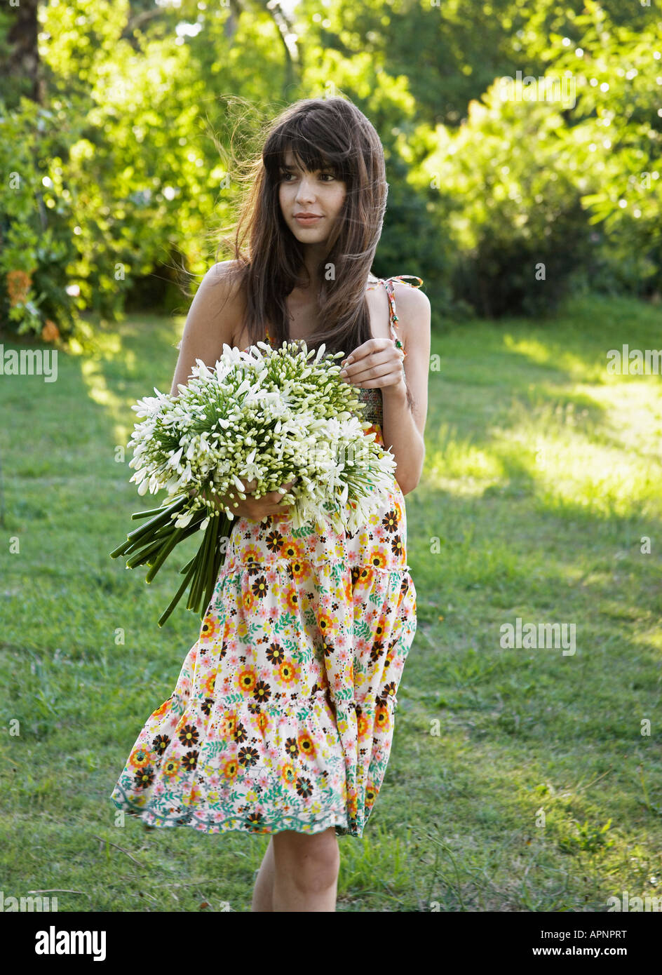 Young Woman Holding Bunch of Flowers Stock Photo - Alamy
