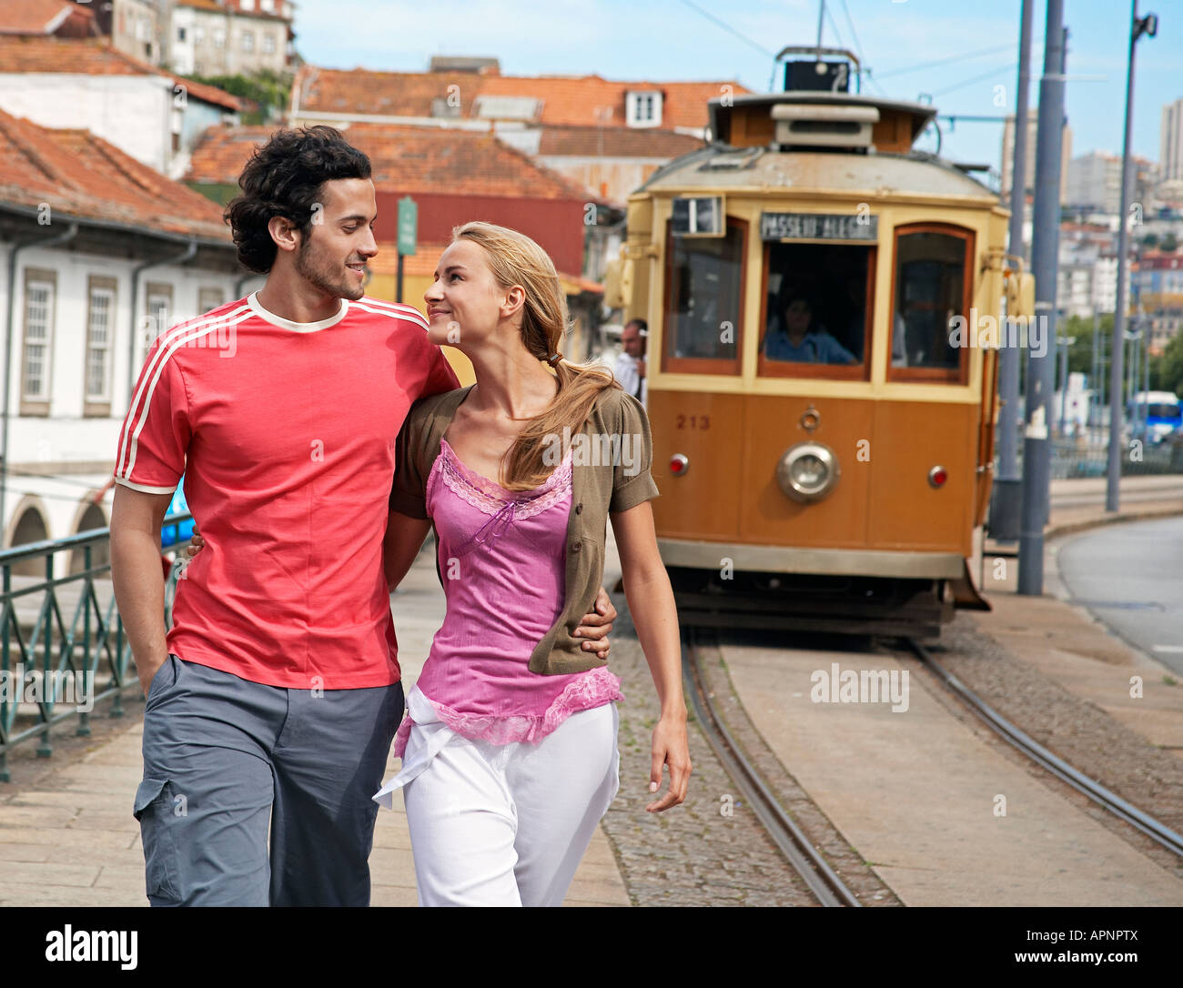 Young couple walking and hugging each other hi-res stock photography ...