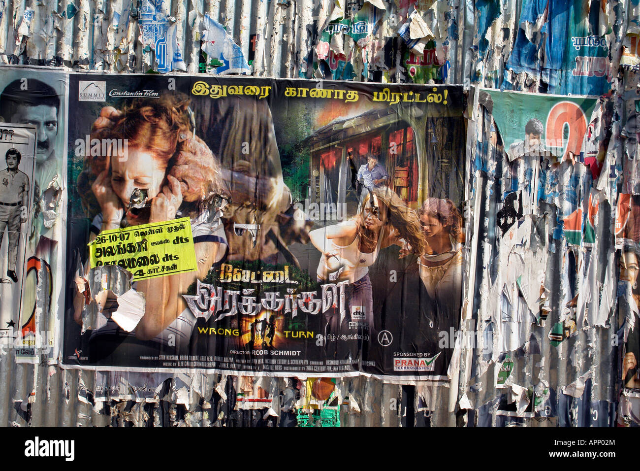 corrugated steel wall hoarding with old advertising posters in madurai