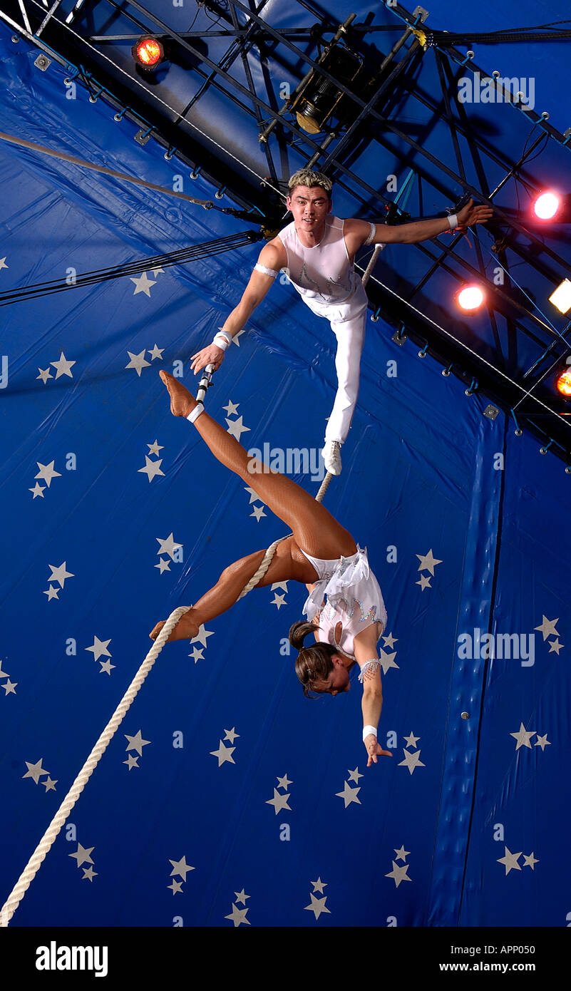 Circus acrobats performing inside the big top Stock Photo