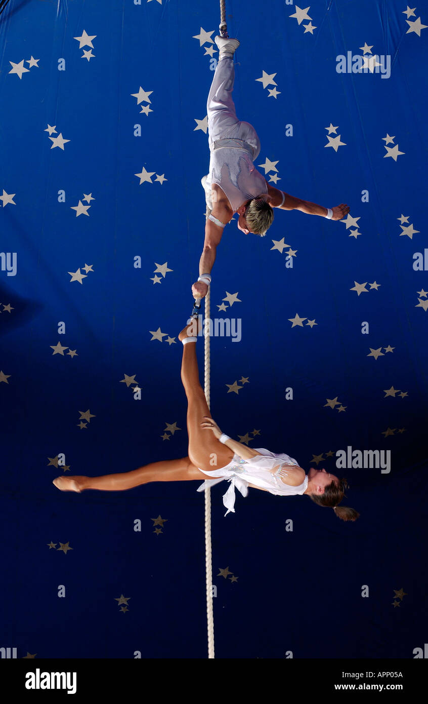 Circus acrobats performing inside the big top Stock Photo