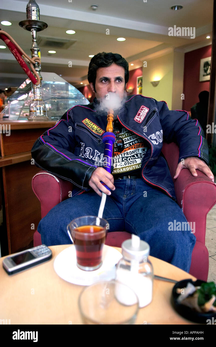 A man smoking a hookah in a cafe on the Edgware Road Londo Stock Photo Alamy