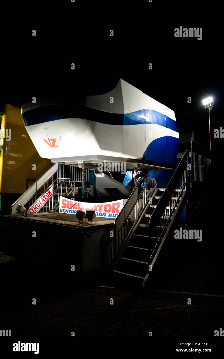 Flight Simulator Ride at Fairground at Night Stock Photo - Alamy
