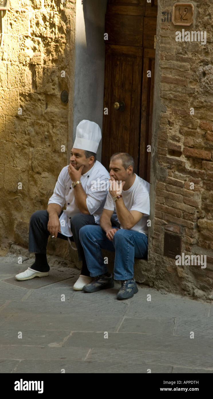 Two chefs take a break before the lunch rush at San Gimignano, in Tuscany, Italy Stock Photo