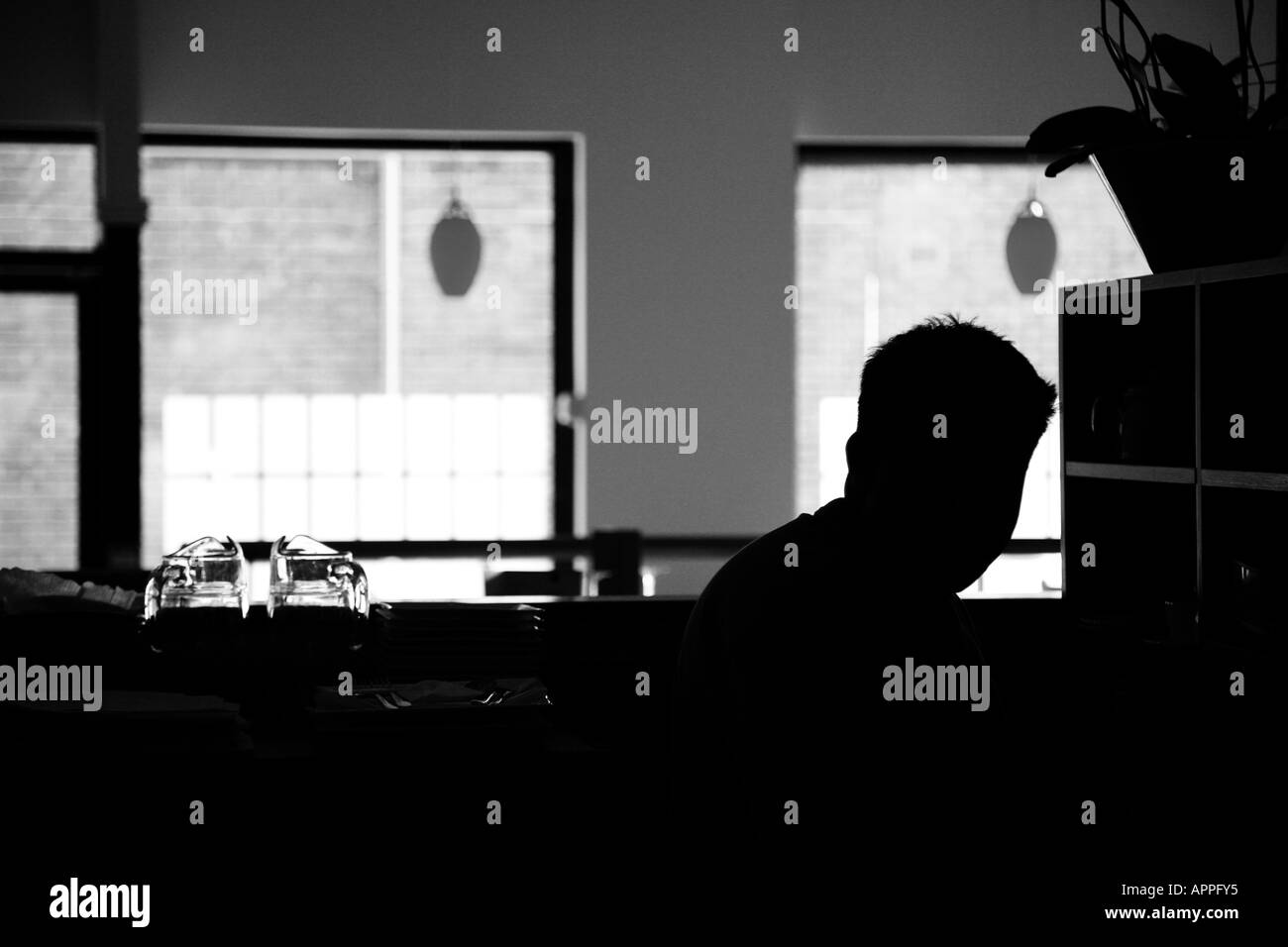 Silluette of man in front of a window in a room Stock Photo