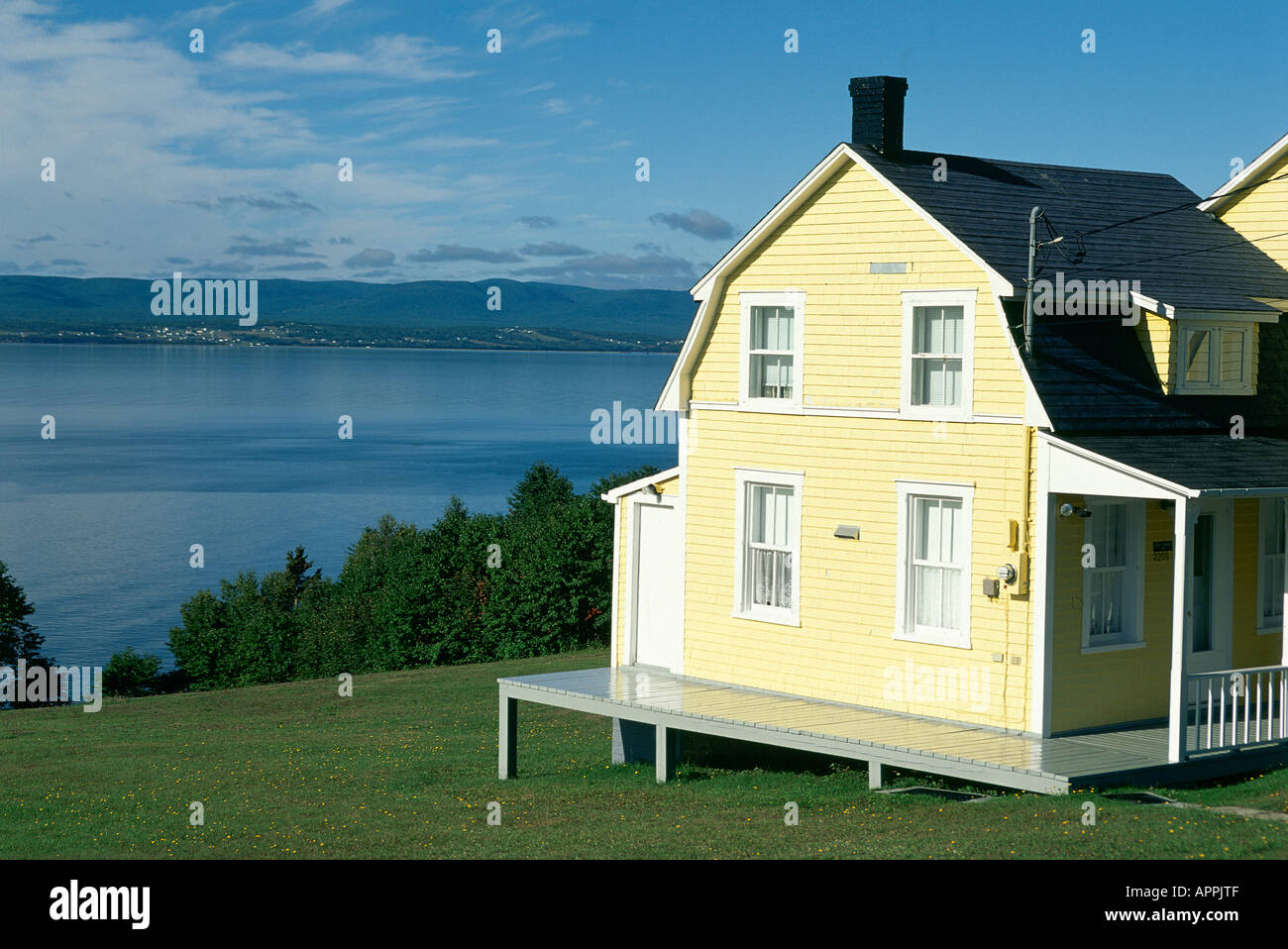 A traditional brightly painted clapboard house overlooking the sea near Gaspe Stock Photo Alamy