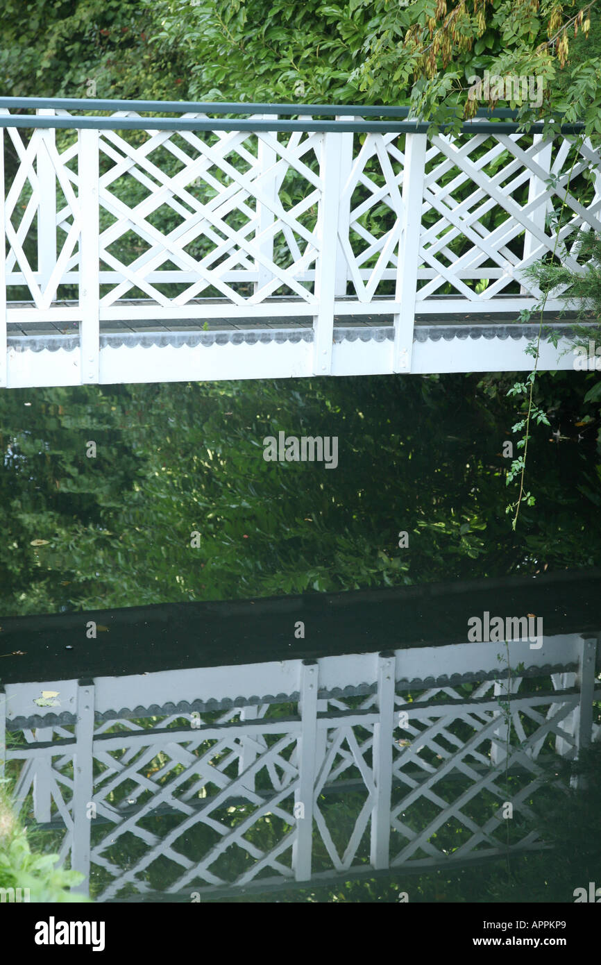 bridge and its reflection on some water in river walk old enfield town london Stock Photo