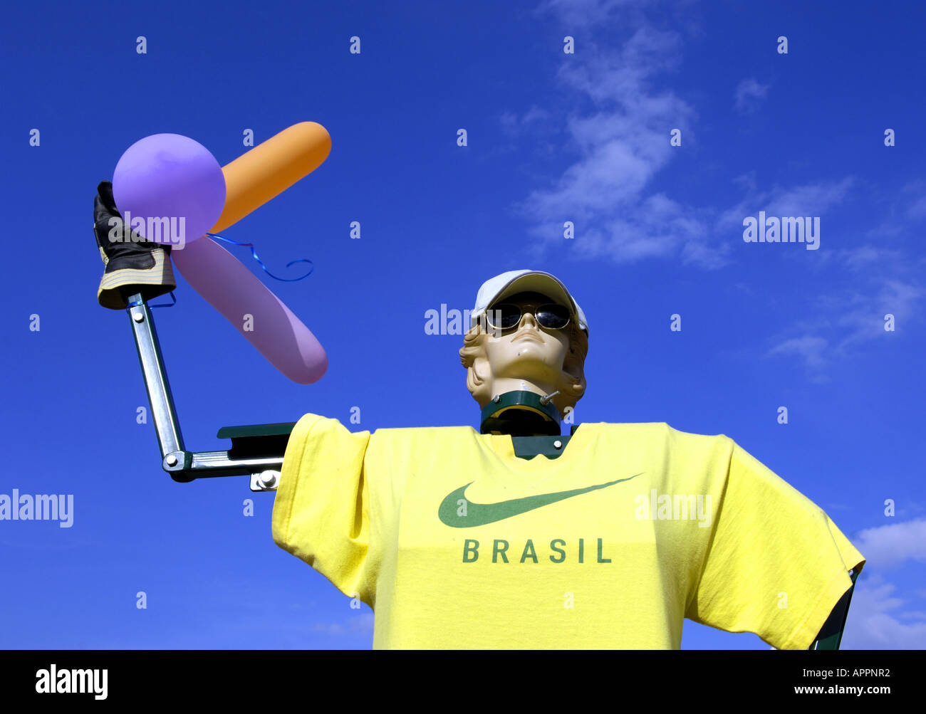 mannequin model dummy female woman hat sunglasses face blue sky head blonde colour color balloons brasil brazil tshirt yellow gr Stock Photo