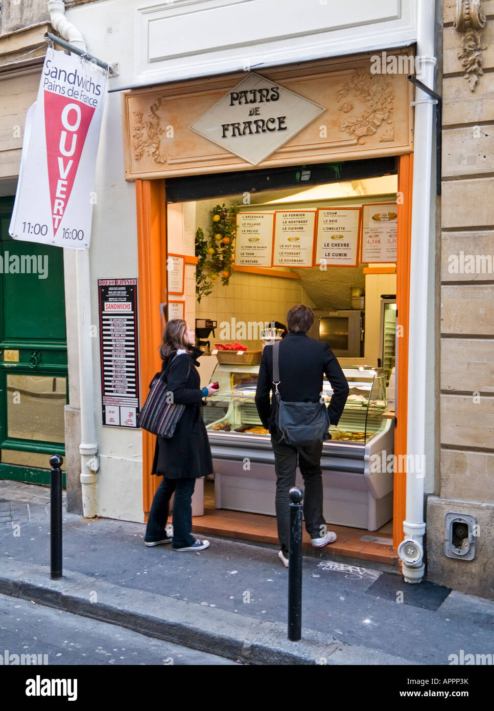 Two students at the counter of a street sandwich shop in the Latin
