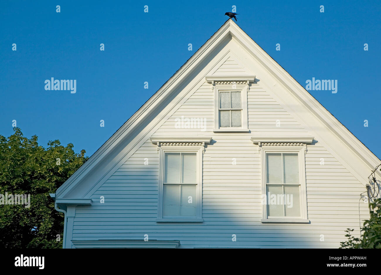 white clapboard house Maine USA New England with triangle shape and many windows Stock Photo