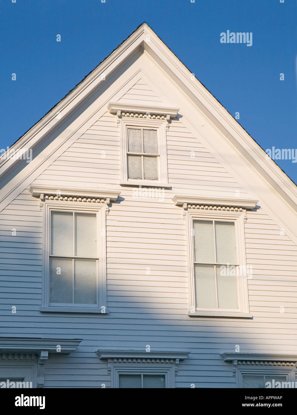 white clapboard house Maine USA New England with triangle shape and many windows Stock Photo