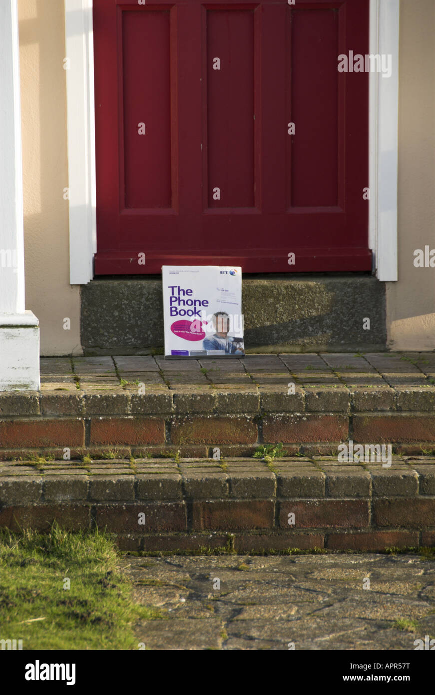 Delivering Telephone Directory on House Doorstep UK Stock Photo