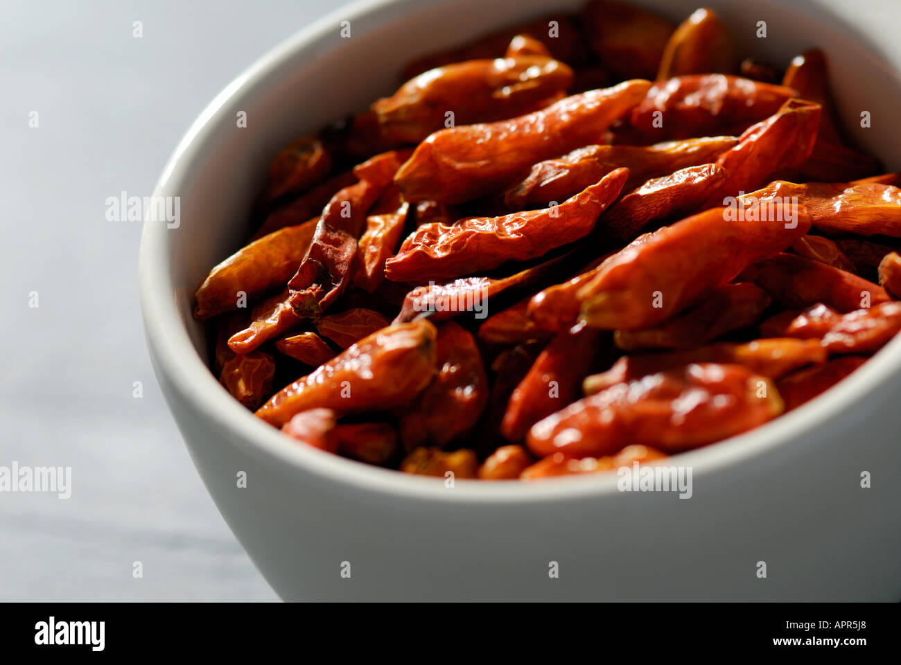 dried chilli peppers in white bowl Stock Photo