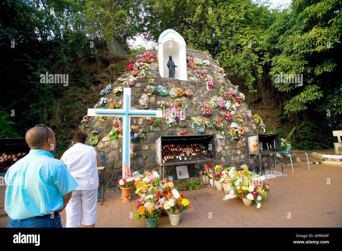 Pilgrims make offerings and prayer at the grotto of La Vierge Noire in