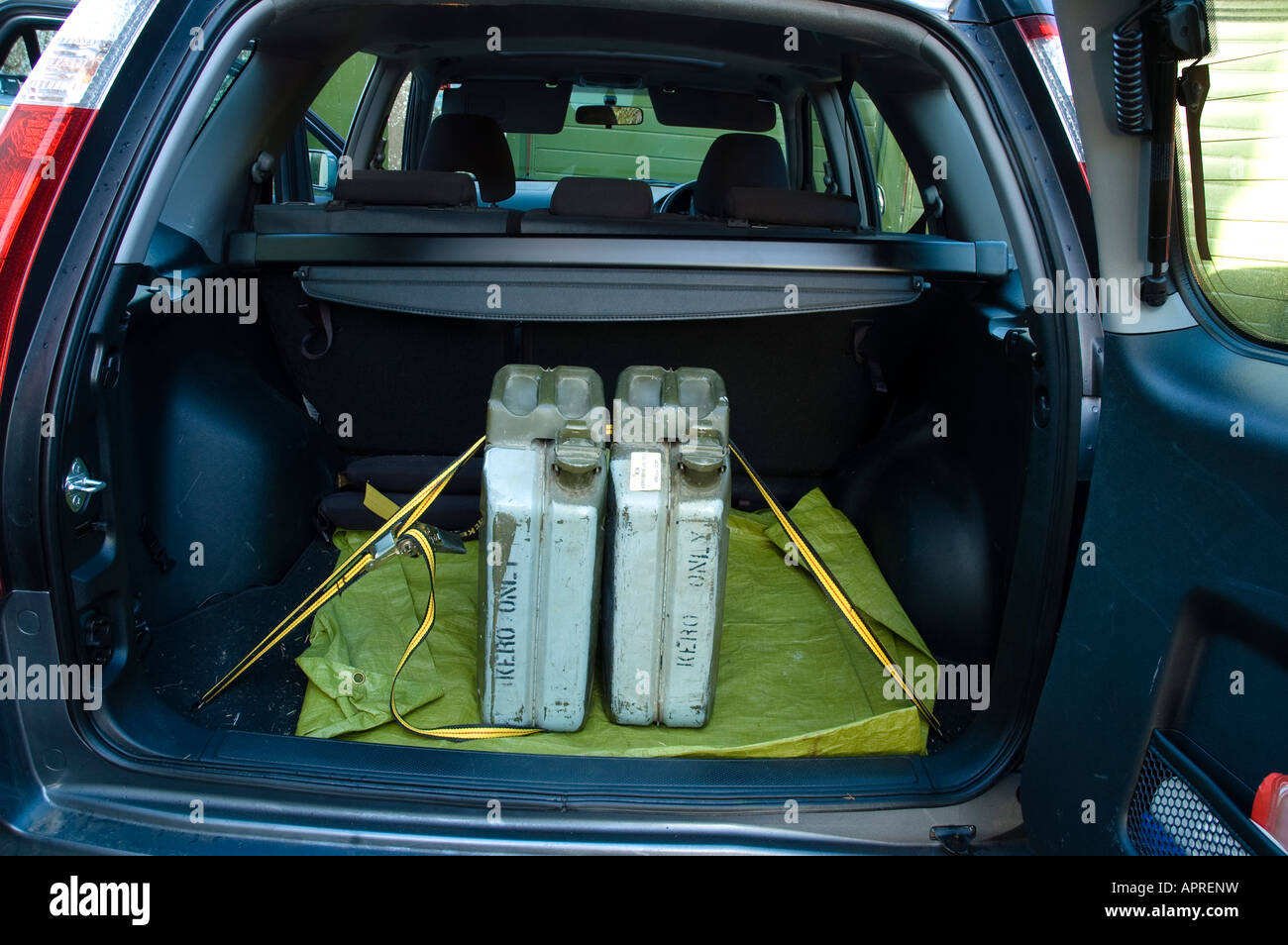 Two spare military surplus fuel canisters in boot of car Stock Photo