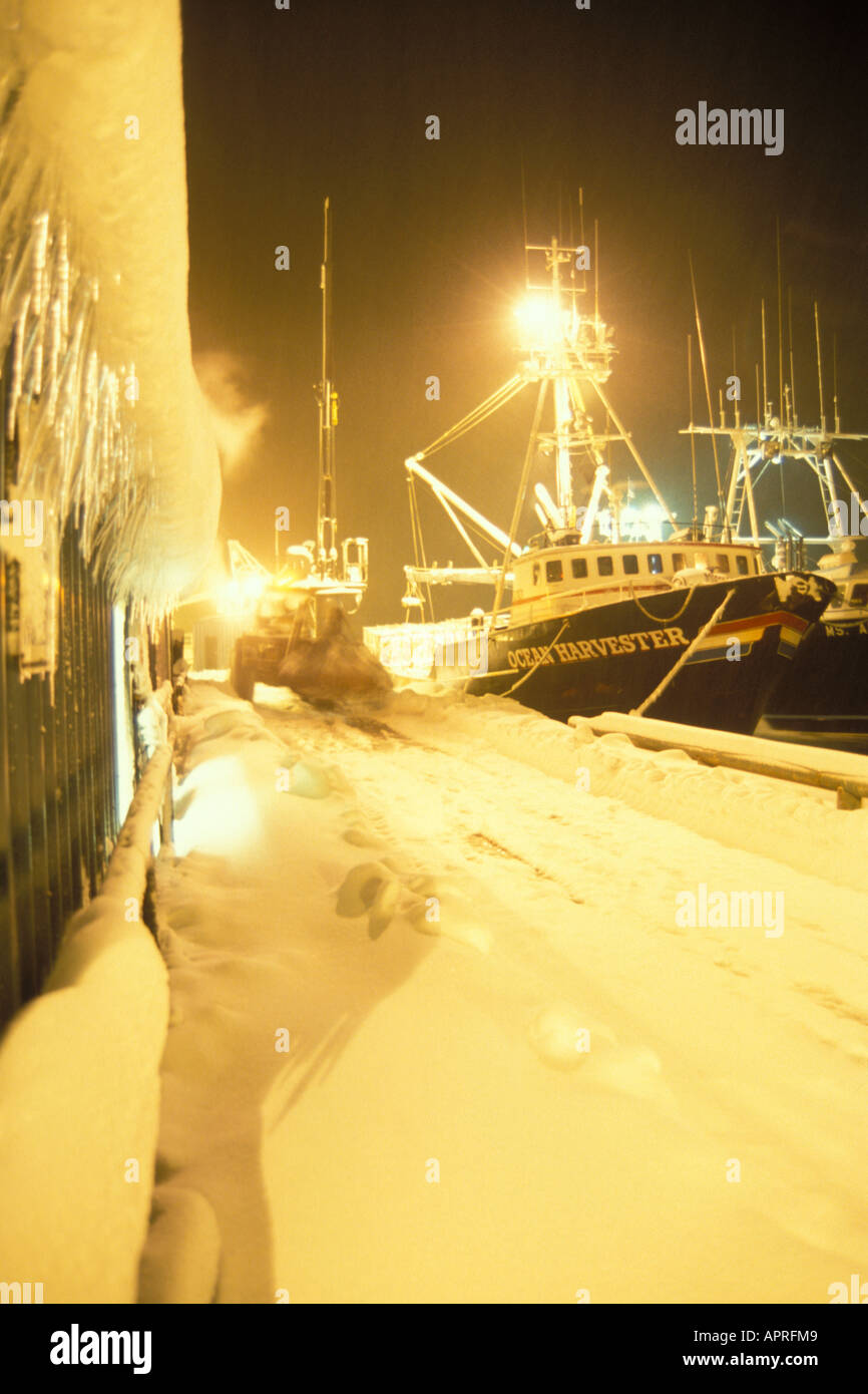 commercial fishing vessel at Trident dock during a winter storm at night on the Aleutian Chain Alaska dragging Stock Photo