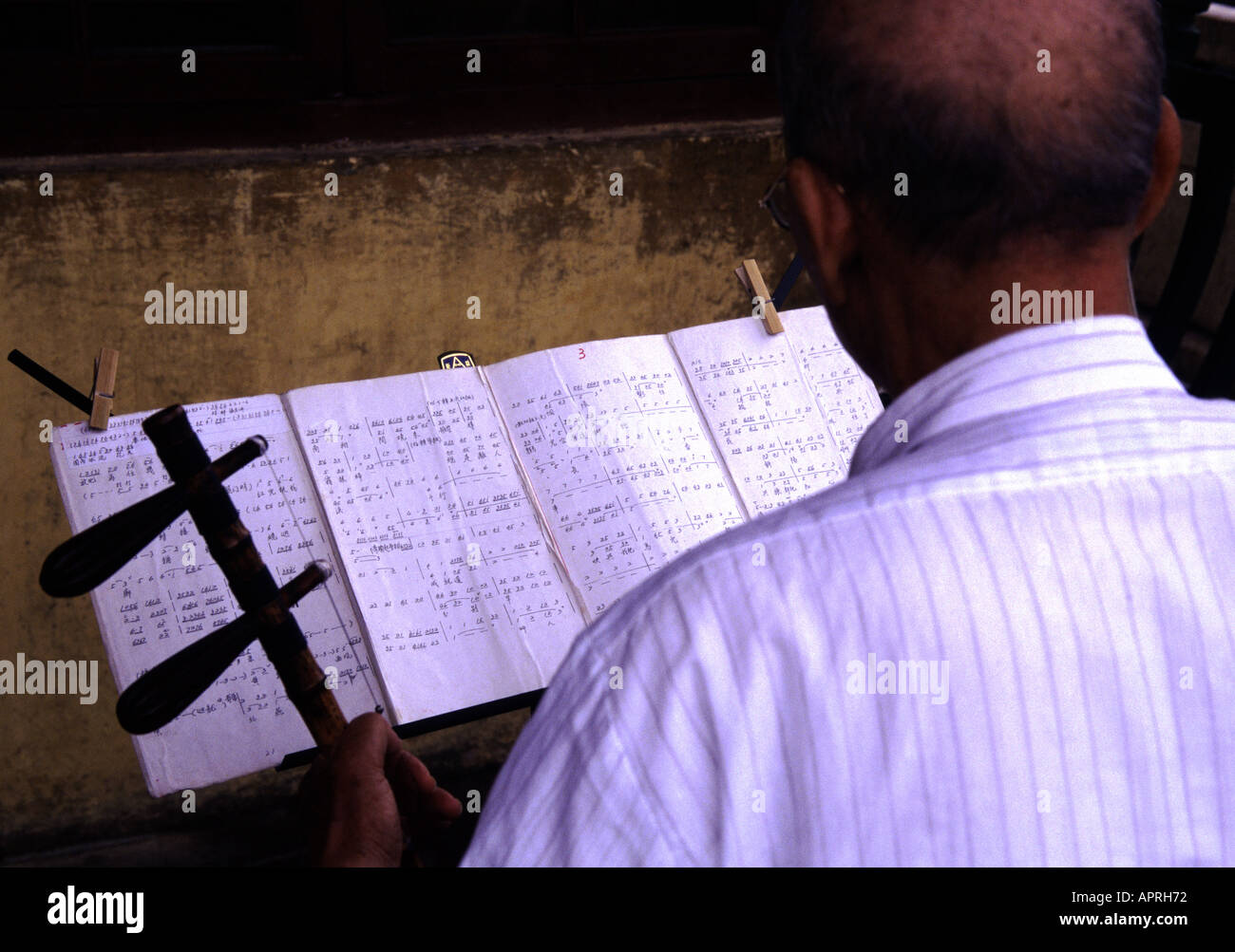 Chinese musician reading chinese musical notation in Kunming Stock