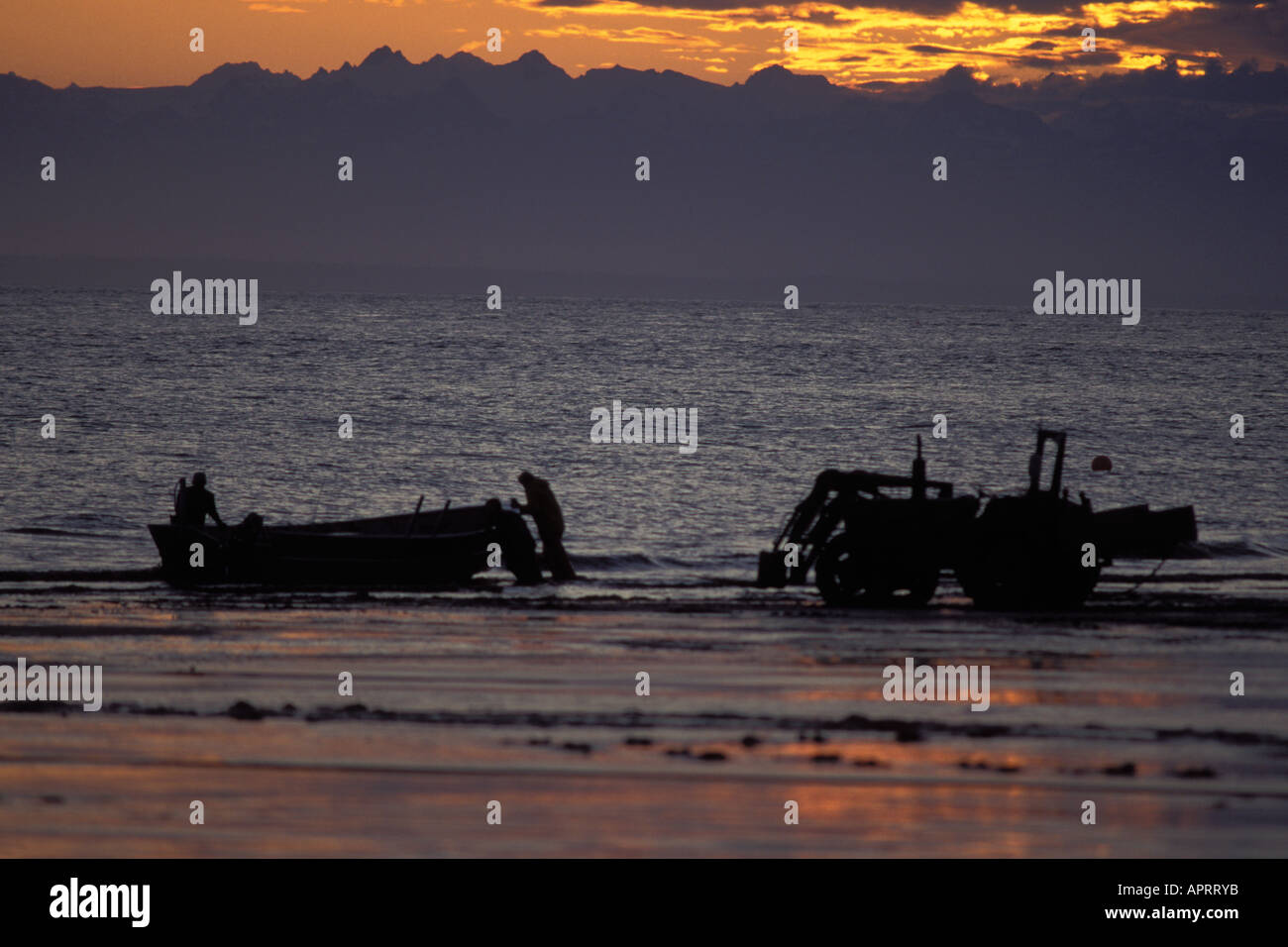 commercial fishing crew during sunset at the mouth of the Kenai river