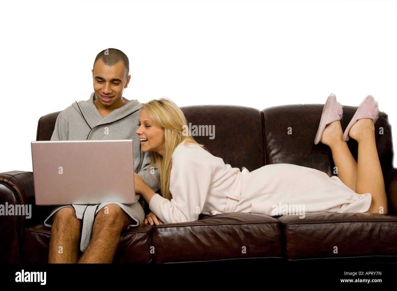 couple sitting on the sofa using a laptop Stock Photo - Alamy