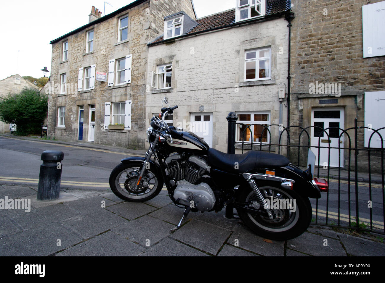 Harley Davidson motorbike parked outside a cottage in Bradford on Avon