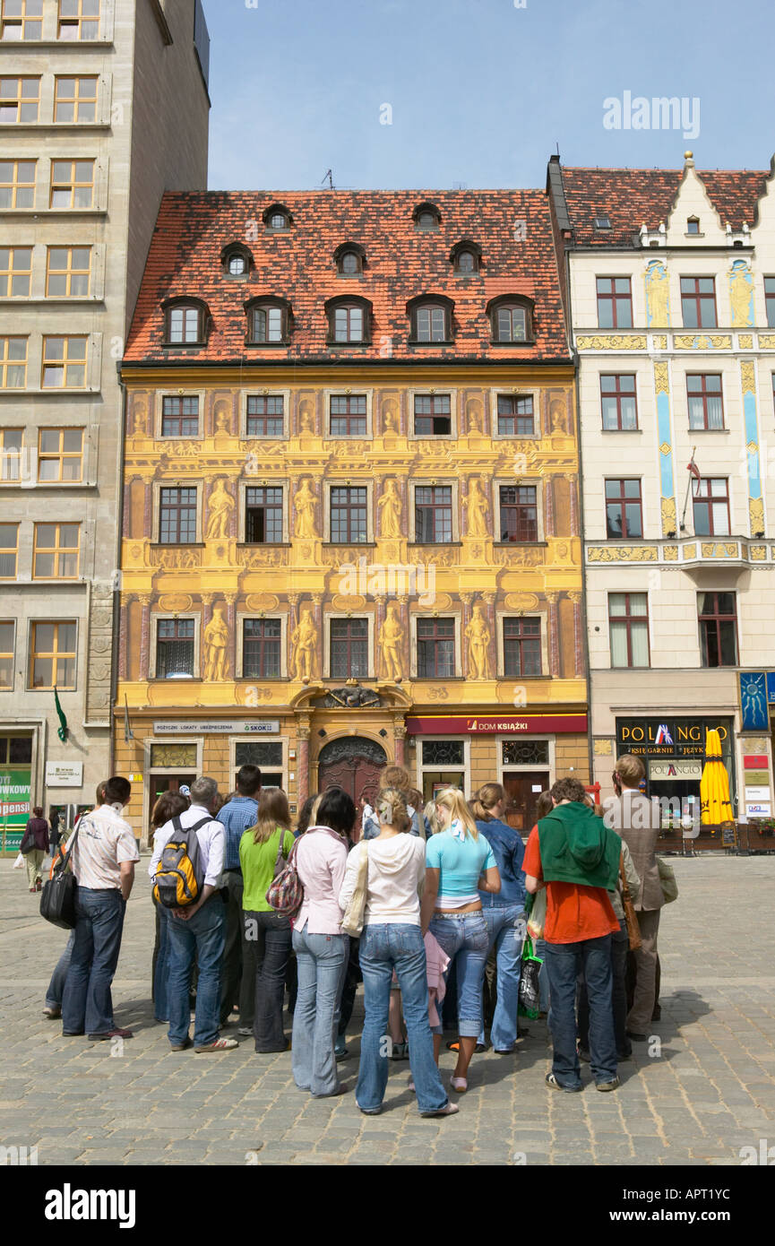 Poland Dolnoslaskie Wroclaw Painted Facade of Seven Electors House Rynek Market Square Students Foreground Stock Photo