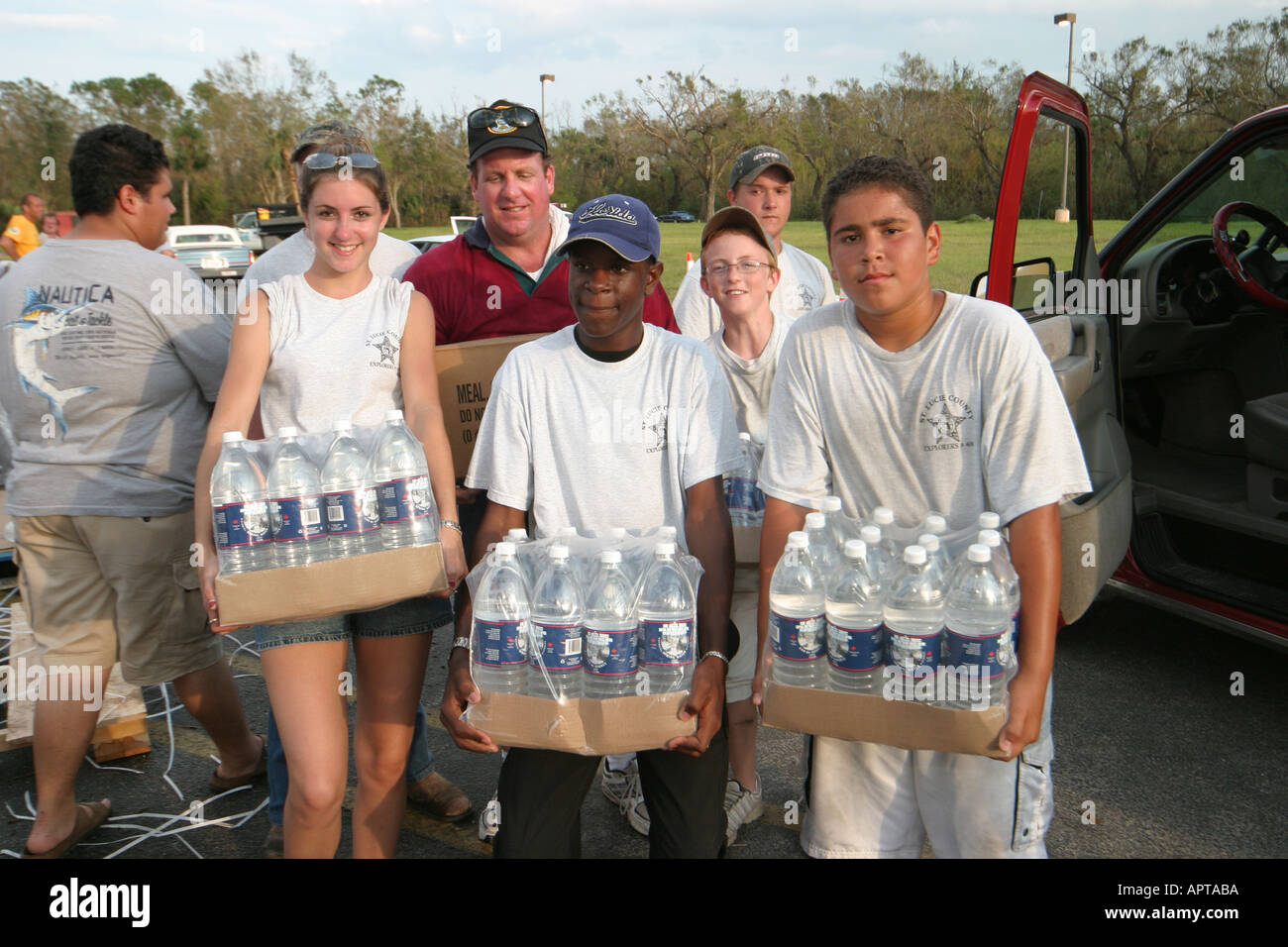 Florida Vero Beach Hispanic teen boy girl teens teenagers students volunteers offer free bottled water carrying offering after Hurricane Jeanne Stock Photo