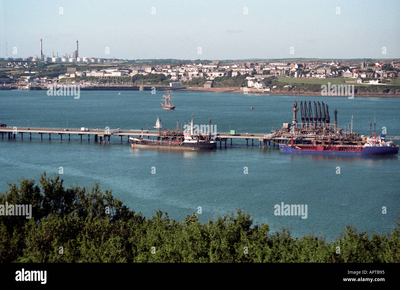 View across the estuary towards Milford Haven oil refinery Stock Photo