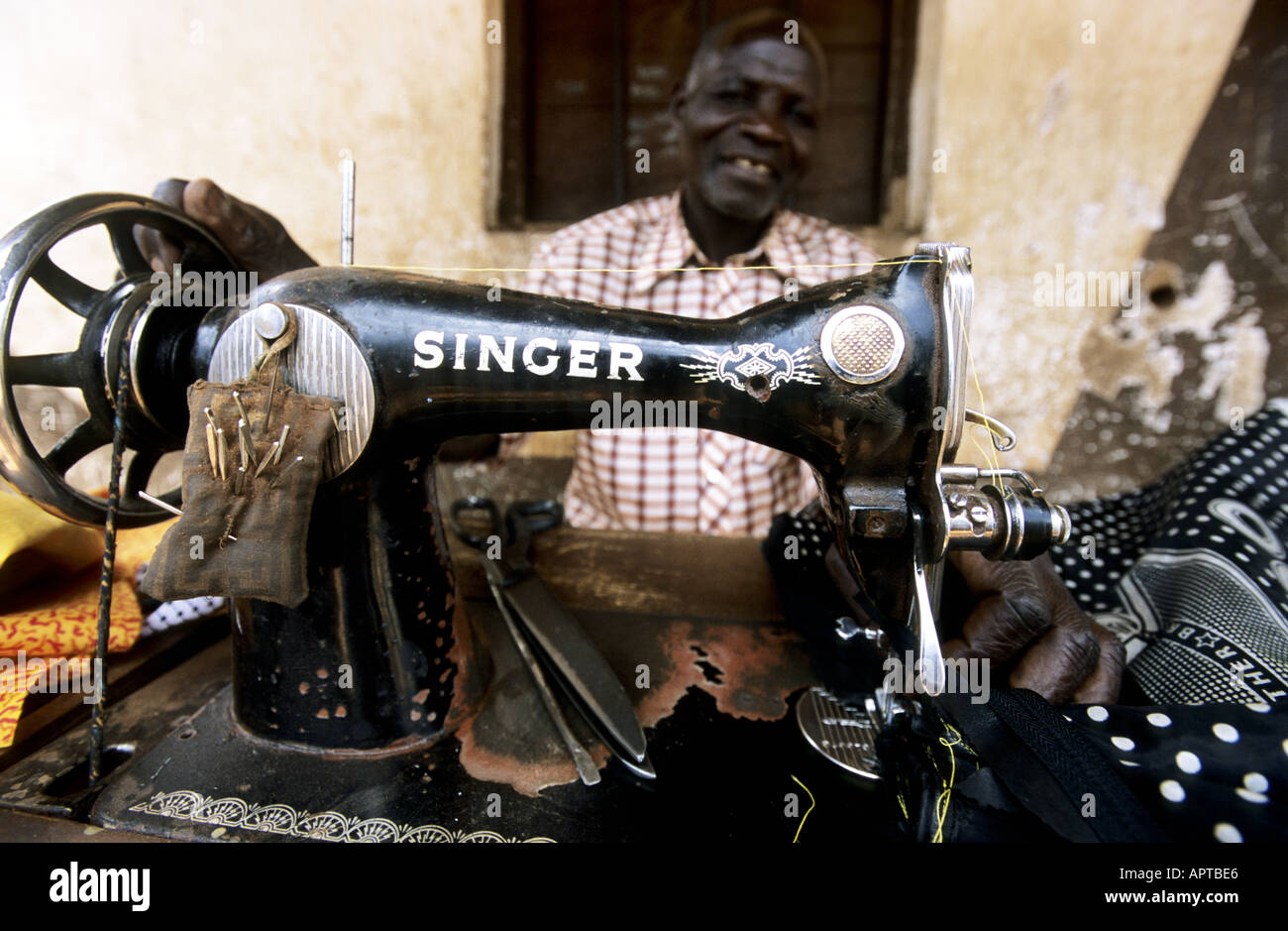 Malawi East Africa Msakambewa Tailor behind his Singer sewing machine