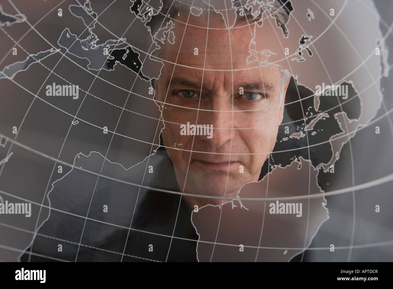 Businessman looking at clear globe Stock Photo - Alamy