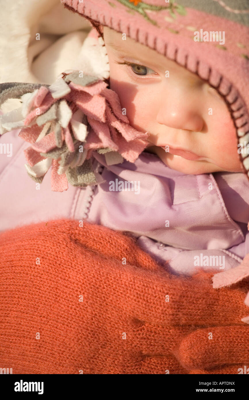 8 month old baby girl wrapped up in winter clothes Stock Photo