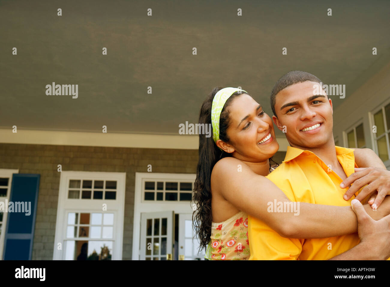 Hispanic couple hugging outdoors Stock Photo - Alamy