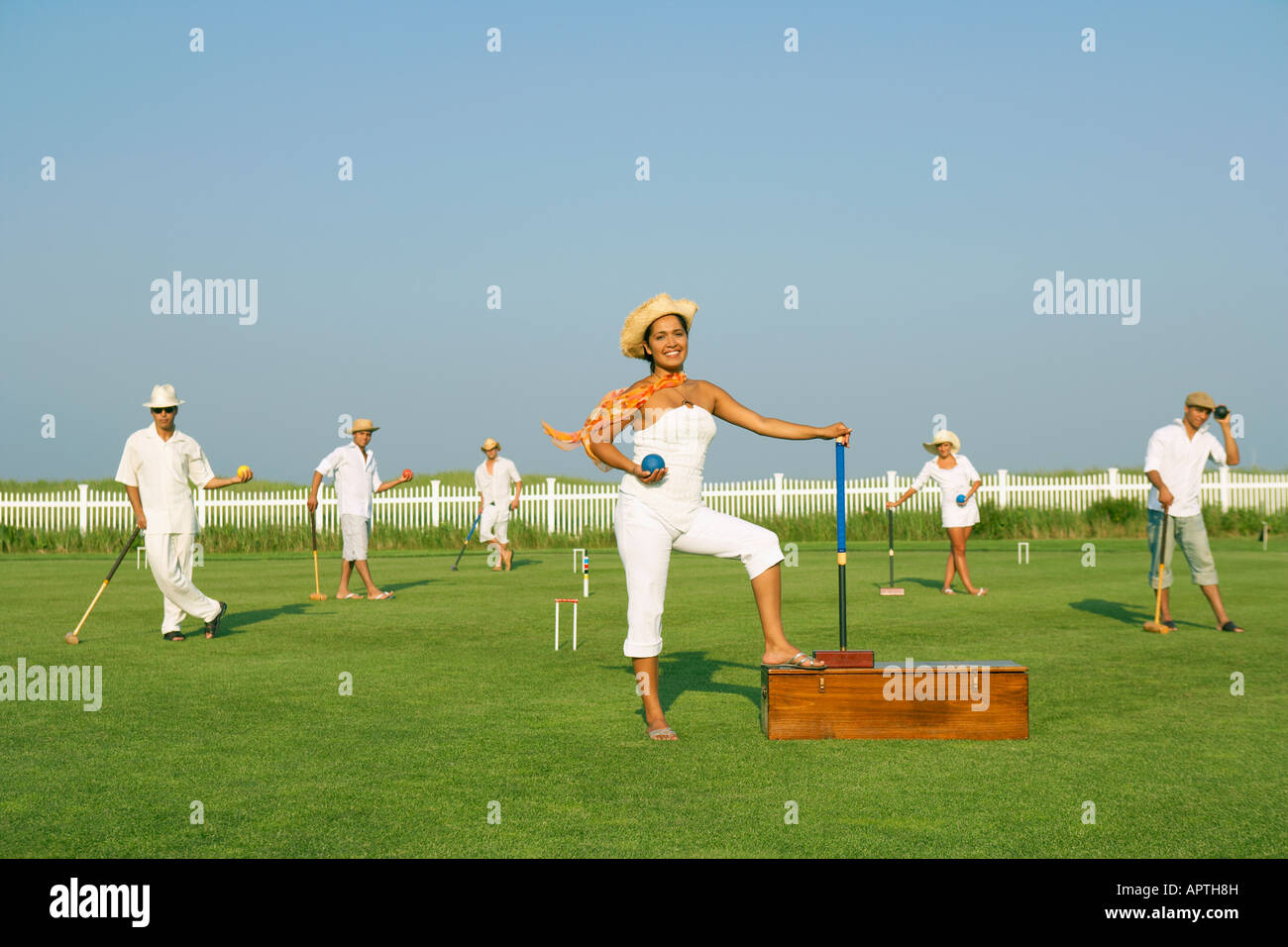 Multiethnic friends playing croquet Stock Photo Alamy