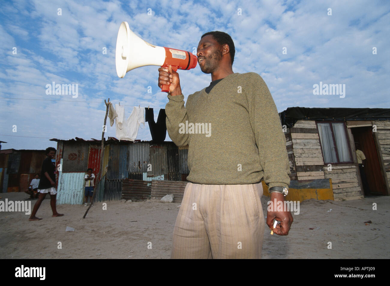 man with bullhorn Kayhelitsha township outside Cape Town Stock Photo