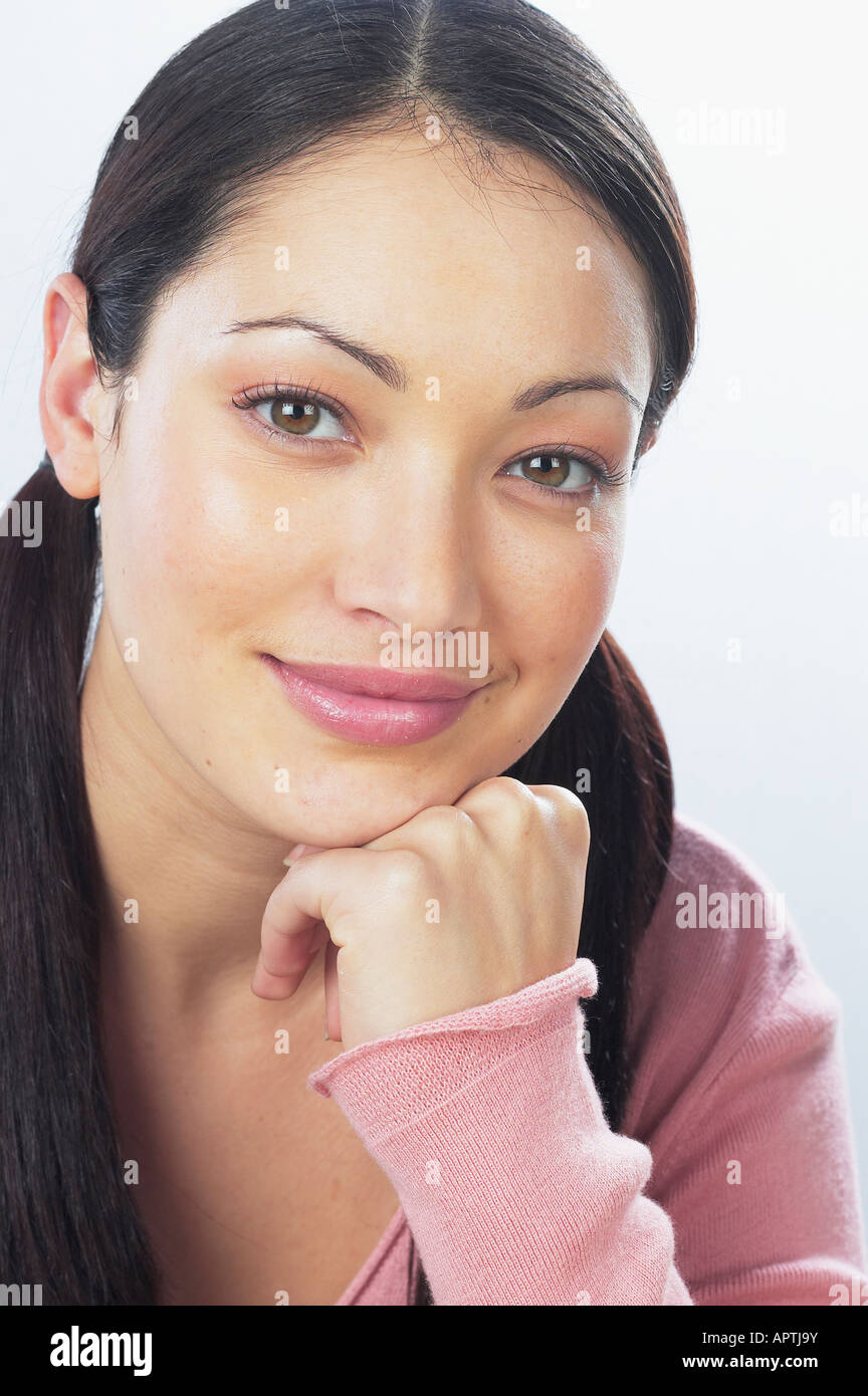 Young woman resting chin on hand hi-res stock photography and images ...