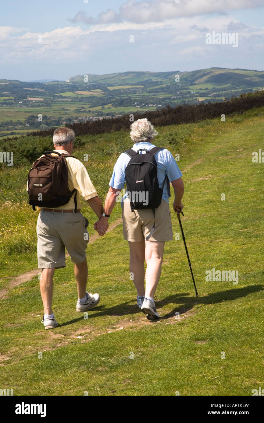Retired couple walking along Nine Barrow Down from Swanage to Corfe Castle Purbeck Dorset UK Stock Photo