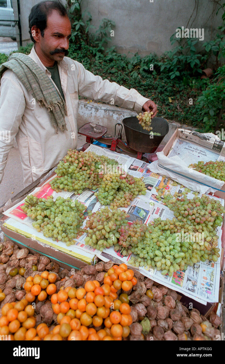A market stall holder selling grapes in India Stock Photo