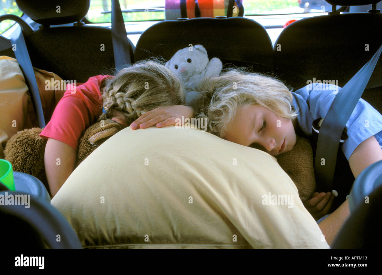 Two girls sleeping in the car Stock Photo