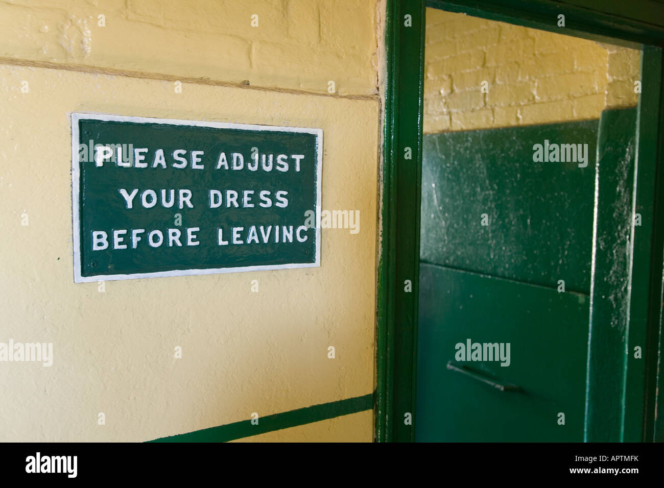 sign saying please adjust your dress before leaving in toilet on Corfe