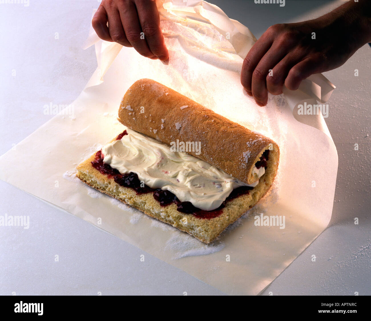 Step to whisked sponge rolling up swiss roll filled with cream and