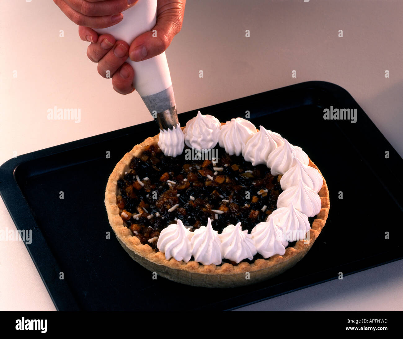 Steps to piping meringue topping on mincemeat pie, Stock Photo