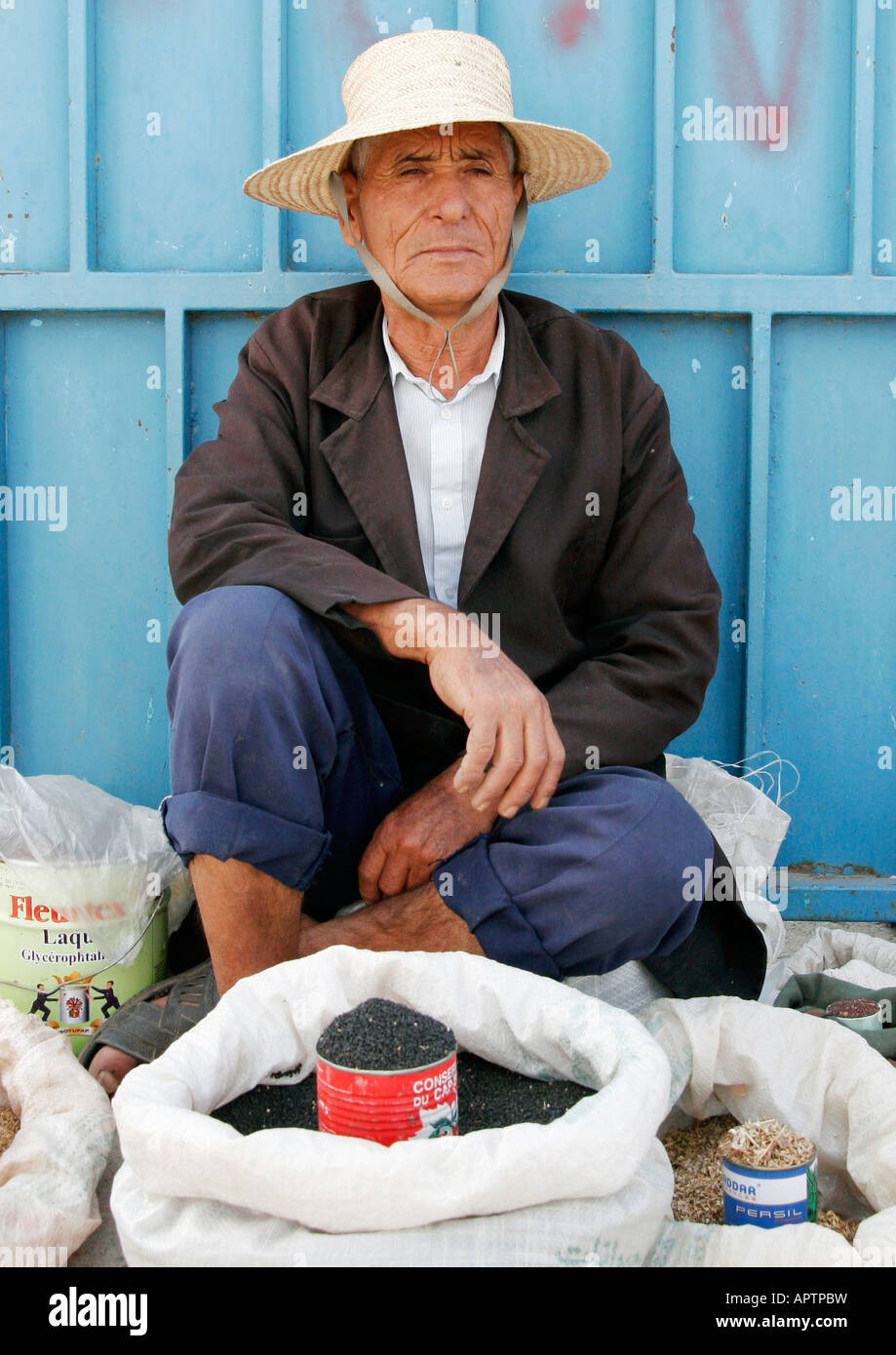A local herb seller, sells his stock in a Tunisian marketplace Stock Photo