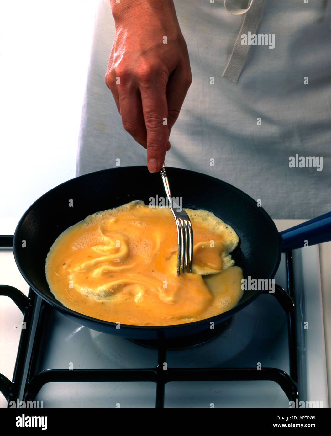 Making omelettes - folding over plain omelette using a large spatula Stock  Photo - Alamy