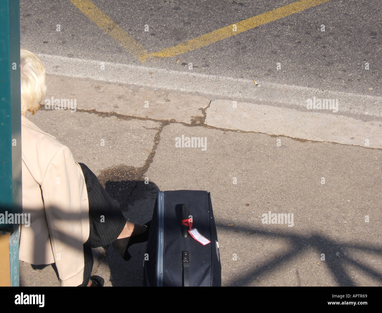woman waiting for bus in town Stock Photo - Alamy