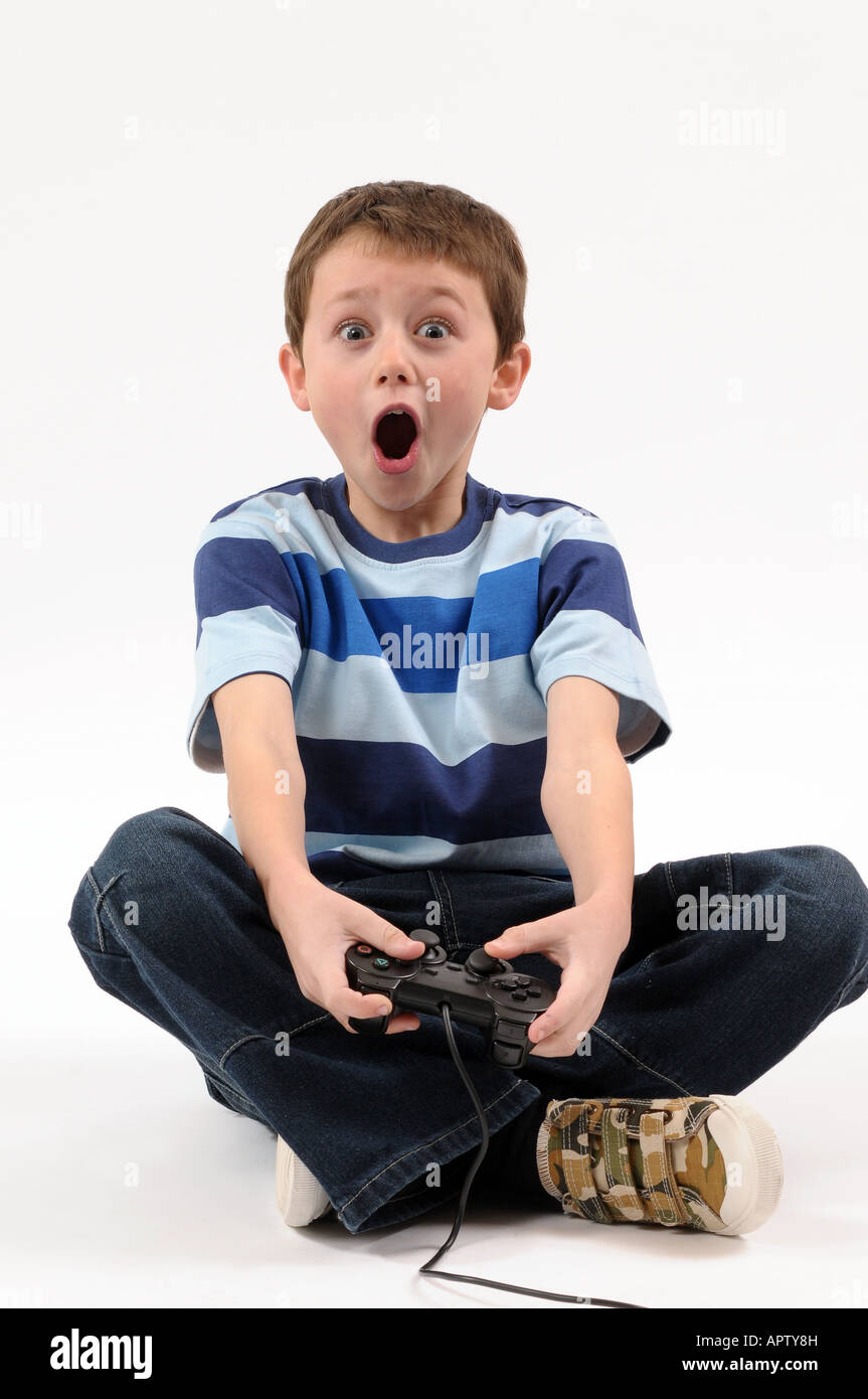 Young boy playing with Sony Playstation style games controller Stock Photo