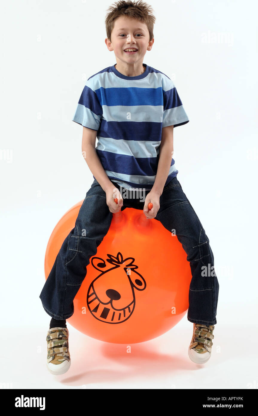 Young boy bouncing on a Space Hopper Stock Photo