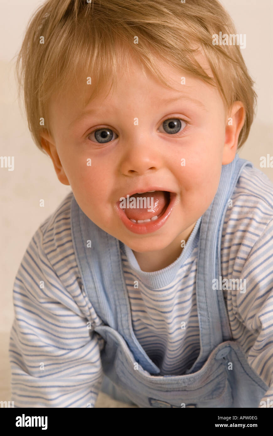 One year old baby boy smiling laughing showing teeth Stock Photo Alamy