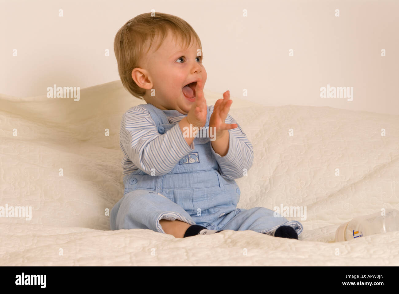 One year old baby boy clapping laughing Stock Photo Alamy