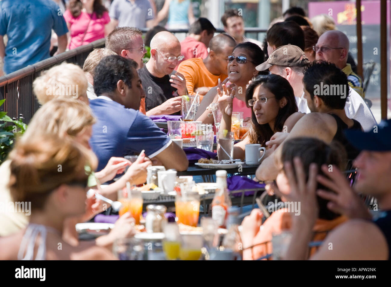 Busy outdoor restaurant patio, multi-ethnic mix of people Stock Photo