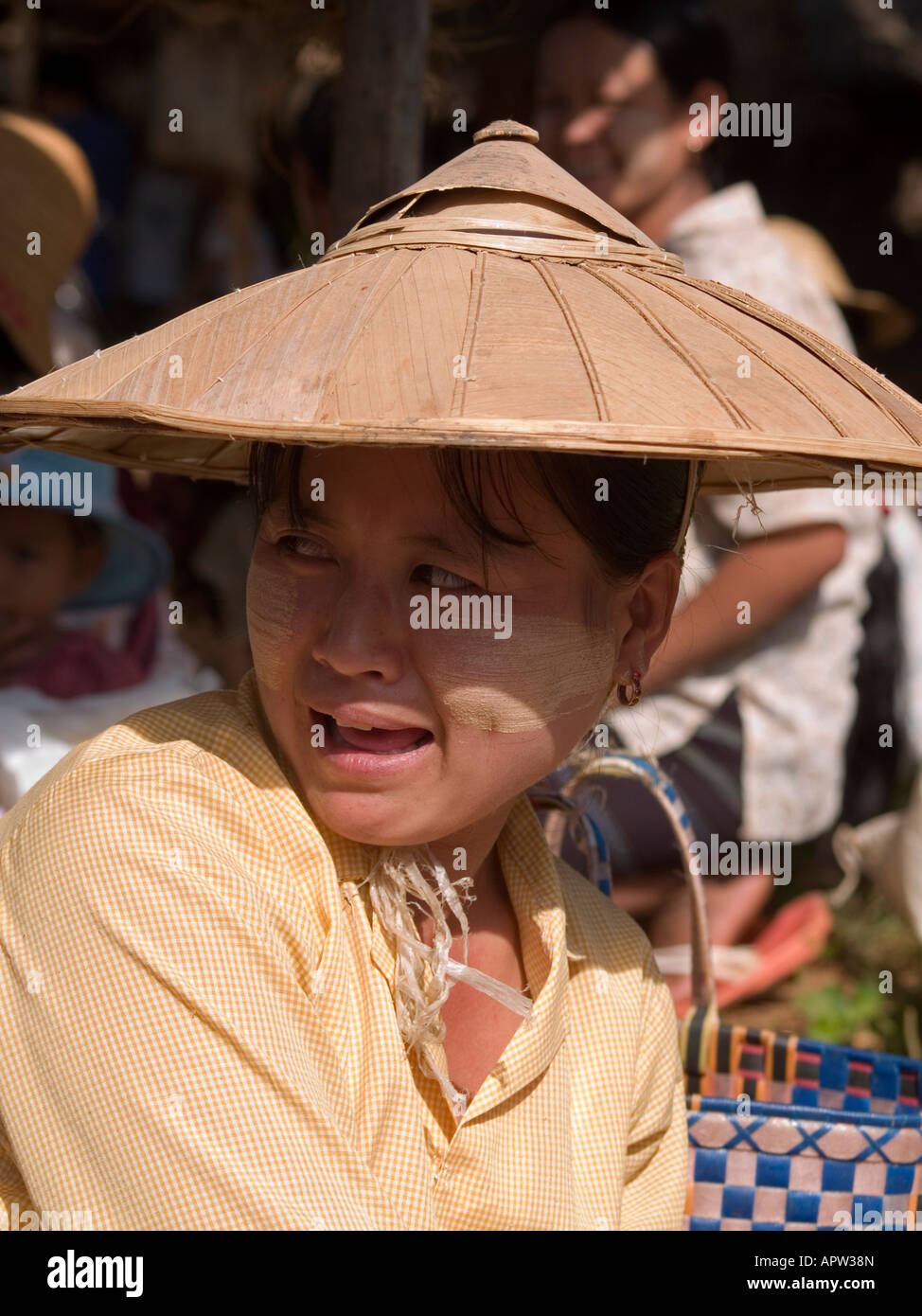 Shan woman in traditional hat and thanaka face paint at Inle Lake in
