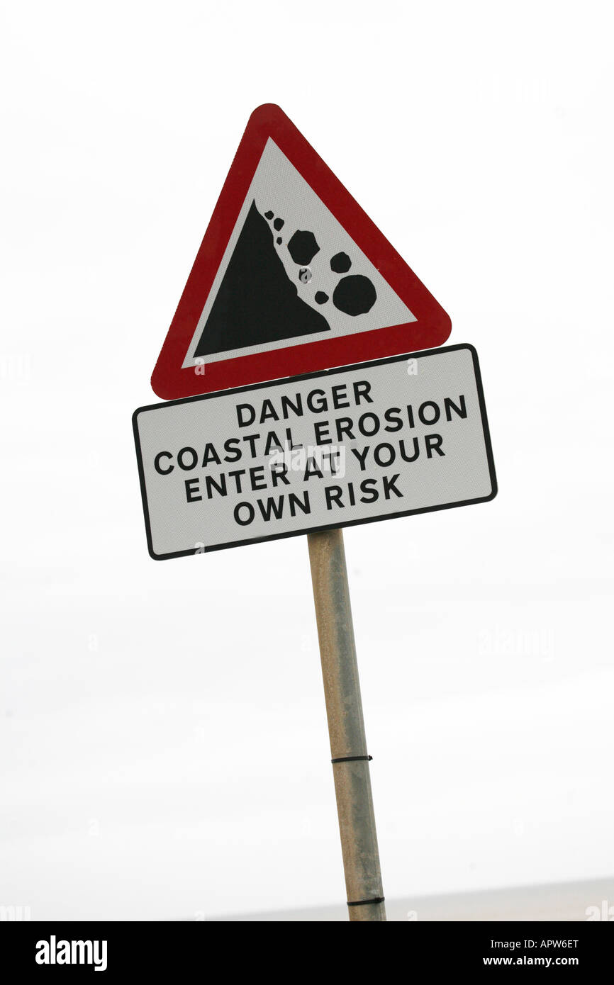 Coastal Erosion on the Yorkshire Coast between Bridlington and Hornsea. Sign warning of dangerous cliff edge and rock falls Stock Photo
